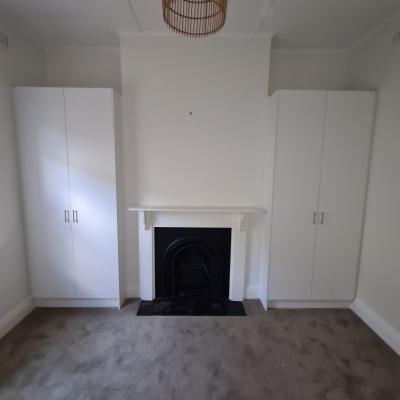 Cupboards either side of the fireplace